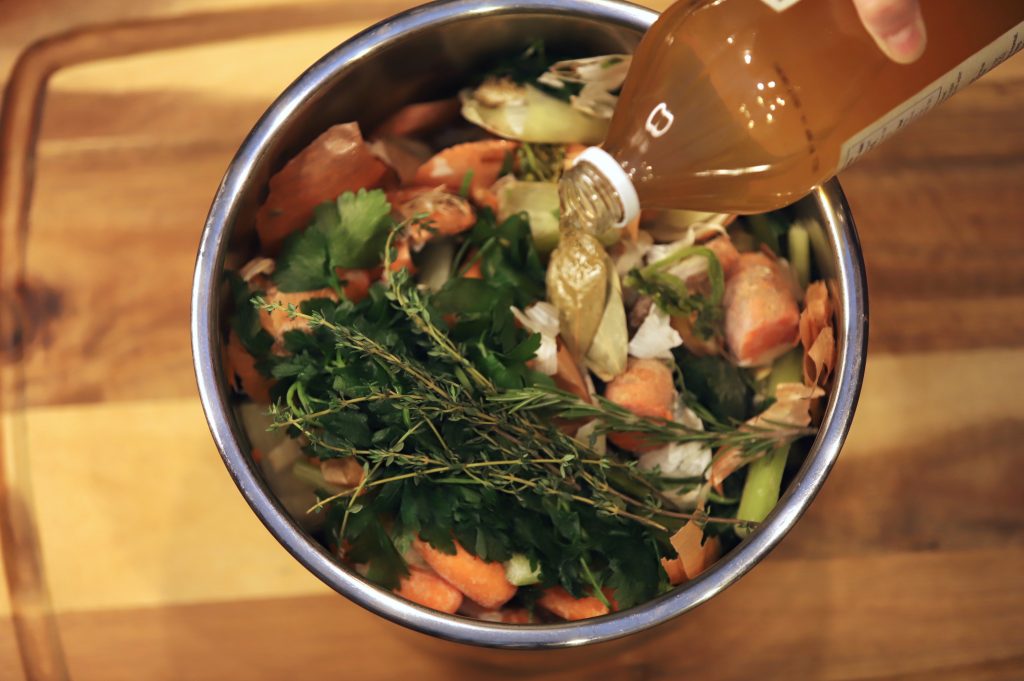 apple cider vinegar into a pot for bone broth