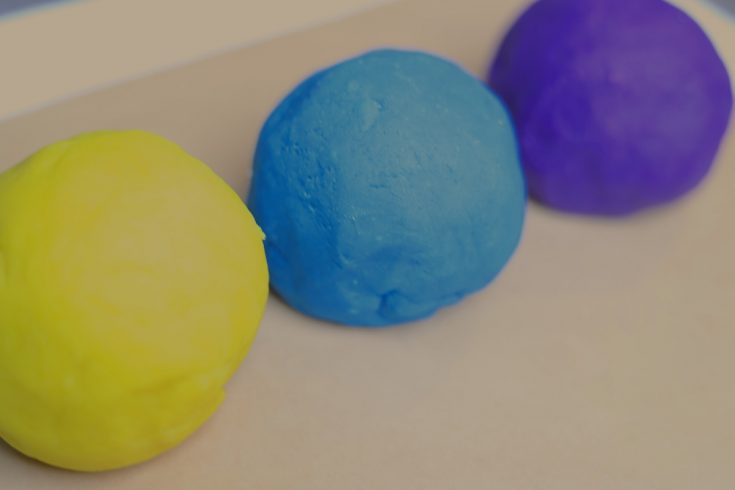 purple, blue, and yellow balls of play dough