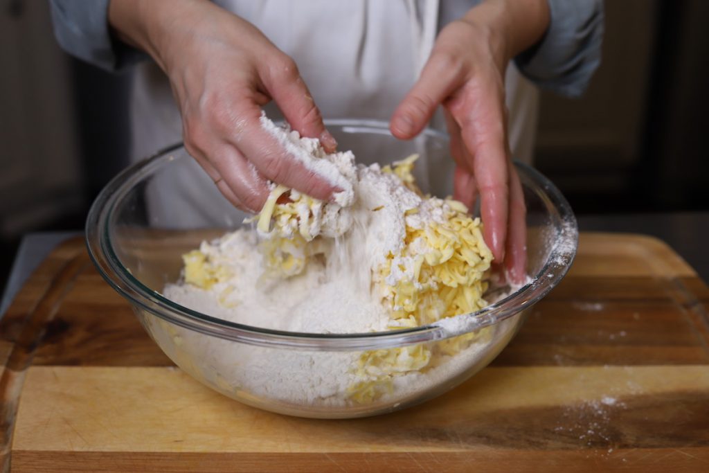tossing butter into flour for pie crust
