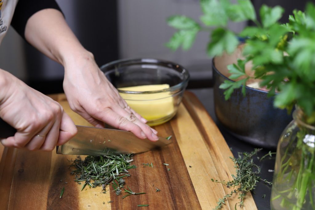 chopping herbs for butter