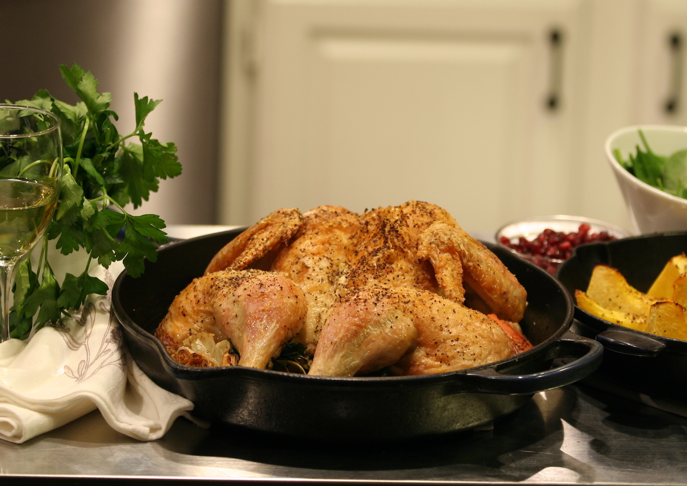 cooked buterflied skillet roasted chicken with wine, acorn squash, and salad