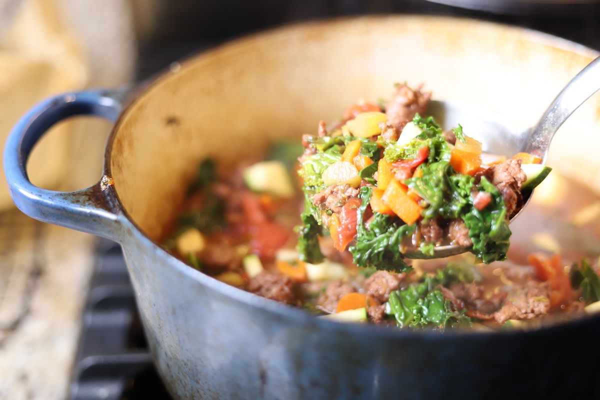 Ladle full of Italian Sausage and Kale soup